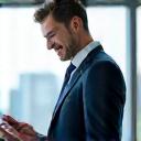 Businessman smiling confidently at a laptop